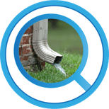 Gutter downspout directing water away from foundation, illustrating property drainage solutions for basement waterproofing.