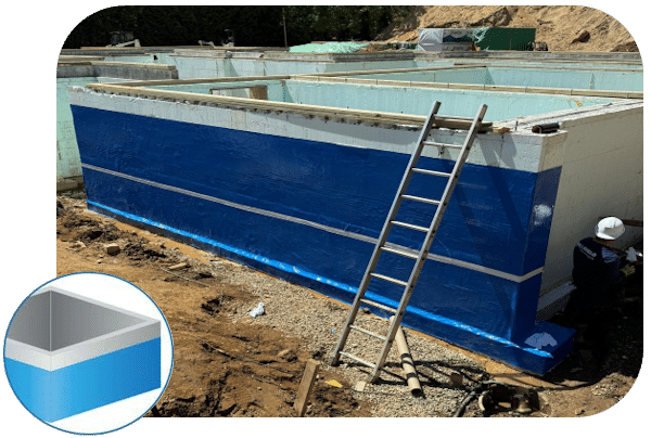 Basement waterproofing installation with blue protective coating, showcasing a foundation wall and ladder, emphasizing water intrusion prevention in Brookville homes.